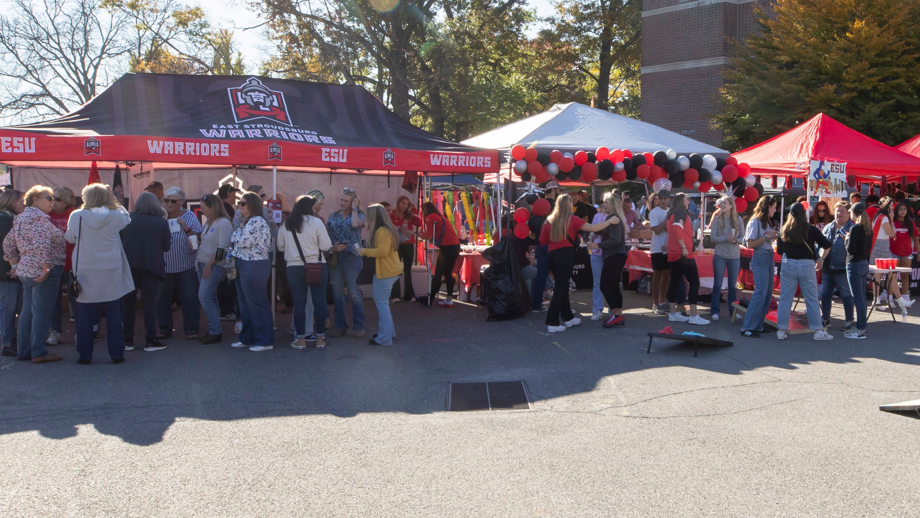 Alumni and friends gather around tailgate tents to celebrate homecoming.